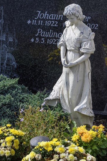 Gravestone with mourning female figure and floral decoration