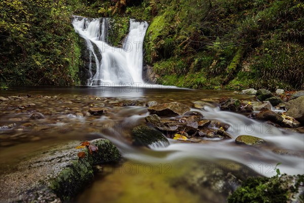 Mountain stream with waterfalls in autumn