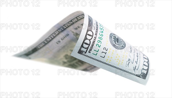 One hundred dollar bill falling or floating on empty background