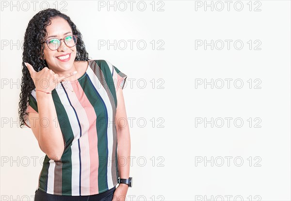 Latin woman in glasses gesturing call with fingers isolated. Happy girl in glasses gesturing call me with hand isolated