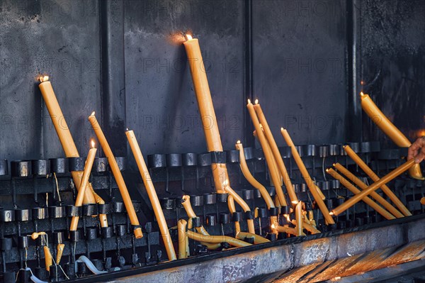 Lighting and burning candles as part of prayer