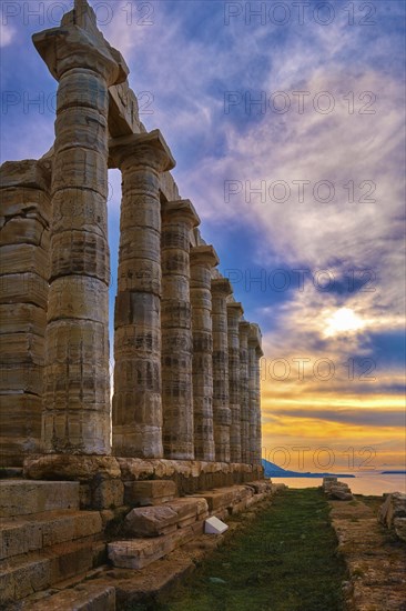 Beautiful sunset sky and ancient ruins of temple of Poseidon