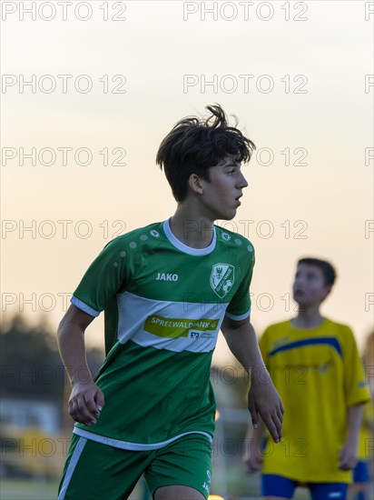 Young football player running across the pitch