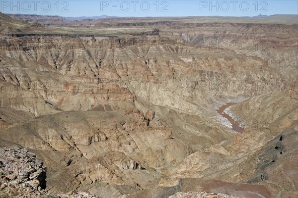 Water of stream flowing through the eroded rocks of the Fish River Canyon