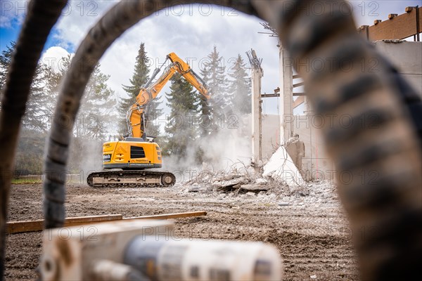 Yellow Liebherr crawler excavator recycling on demolition site