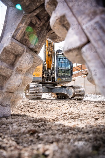 Yellow Liebherr crawler excavator recycling on demolition site