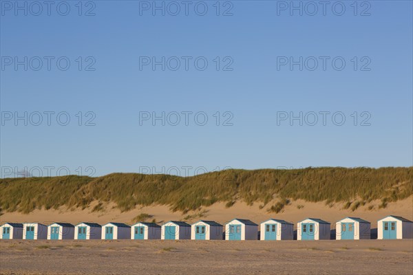Row of blue and white beach cabins on Texel