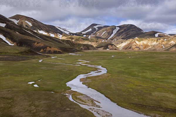 Sulphur coloured rhyolite mountains with patches of snow at Brennisteinsalda volcano near Landmannalaugar