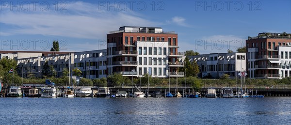 Illegally anchored houseboats in the Rummelsburg Bay with the residential houses on the Rummelsburg shore