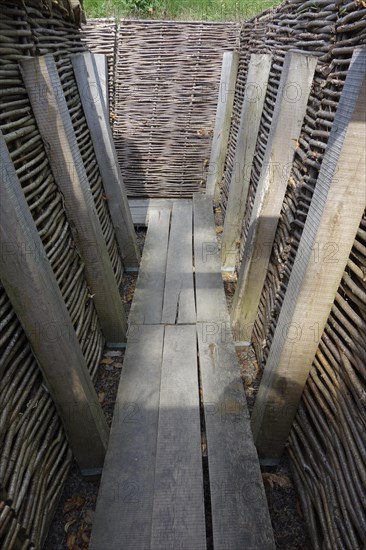 Reconstruction of German First World War One trench showing wooden duckboards and woven wickerwork branches at Zonnebeke