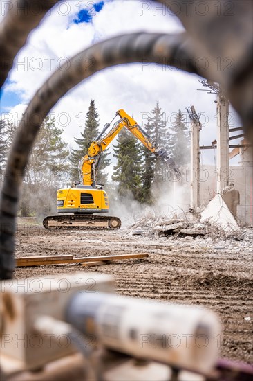 Yellow Liebherr crawler excavator recycling on demolition site