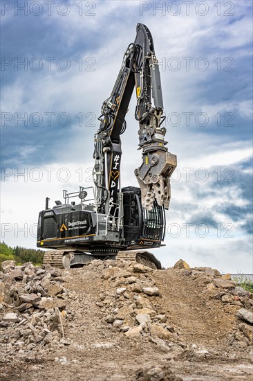 Black Liebherr crawler excavator recycling on demolition site