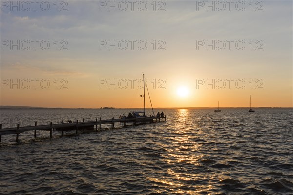 Couple sitting on jetty at Lake Steinhude