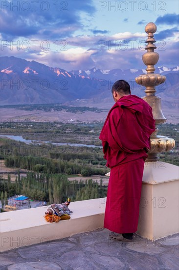 Monk with a blowing conch at Spituk Monastery