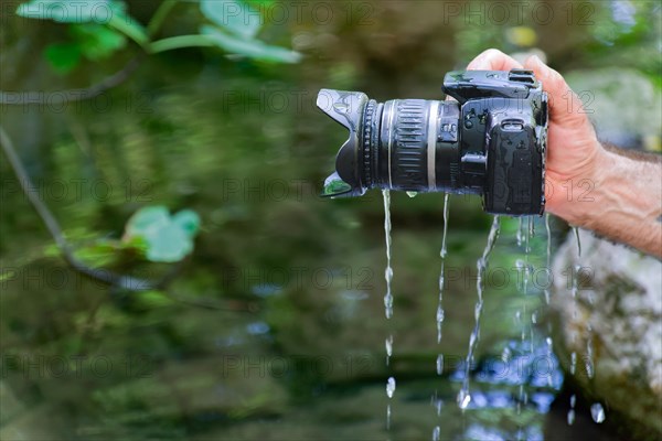 A reflex camera accidentally falls into the river