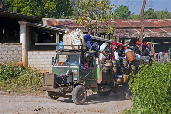 Open truck heavily loaded with villagers