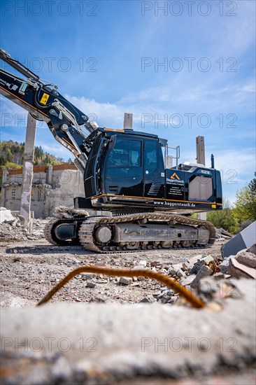 Black Liebherr crawler excavator recycling on demolition site