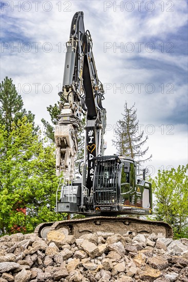 Black Liebherr crawler excavator recycling on demolition site