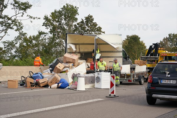 Rescue workers collect the load of a small truck from the carriageway of the A48 motorway in the area of the Koblenz interchange after the collision of the truck with an articulated lorry. Koblenz