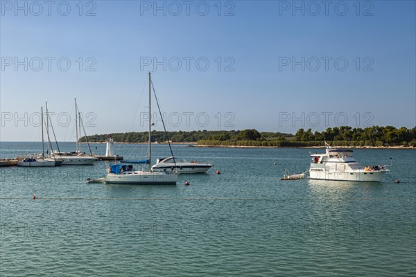 Sailboats anchor in the harbor entrance of Novigrad