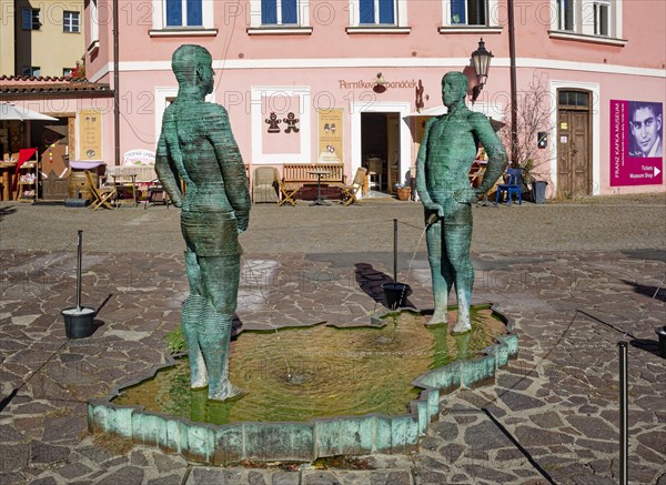 Two male figures peeing