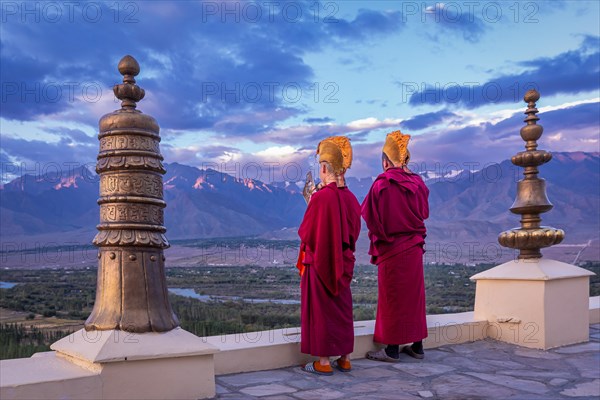 Monks blowing conches at Spituk Monastery