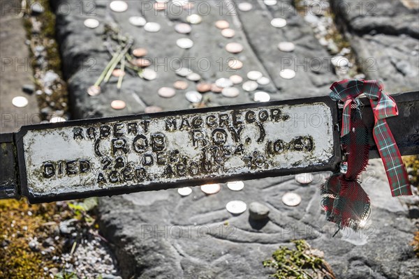 Coins on the grave of Rob Roy MacGregor at the Balquhidder kirkyard