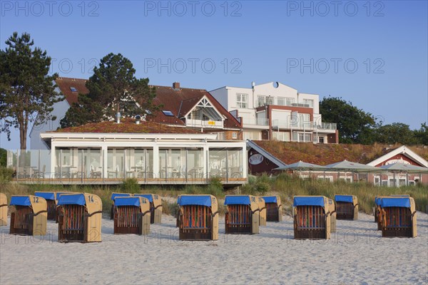 Restaurant and roofed wicker beach chairs along the Baltic Sea at Scharbeutz