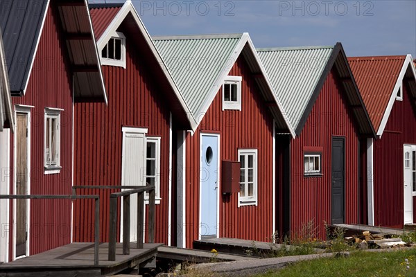 Red wooden boat huts in the harbour at Hamburgsund