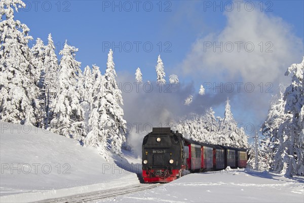 Steam train riding the Brocken Narrow Gauge railway line in the snow in winter at the Harz National park