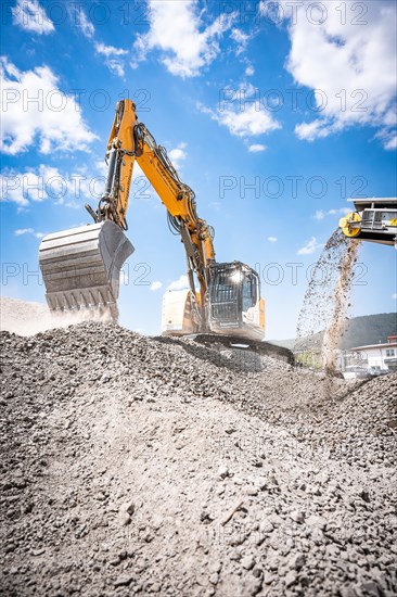 Yellow Liebherr crawler excavator recycling on demolition site