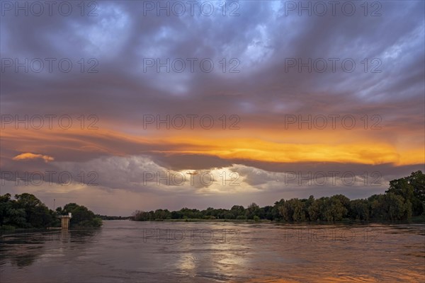 Thunderstorm building at sunset over the Orange river near Upington