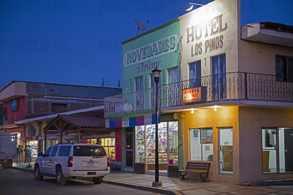 Shops and hotel in main street of the town Creel at night