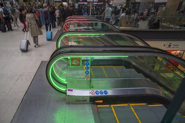 Colourfully illuminated escalators in the Gare de Lyon