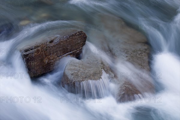 Detail of creek showing water flowing over rocks in the Maligne Canyon
