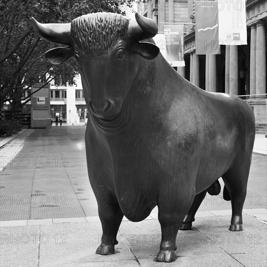 Figure Bull in front of the Frankfurt Stock Exchange