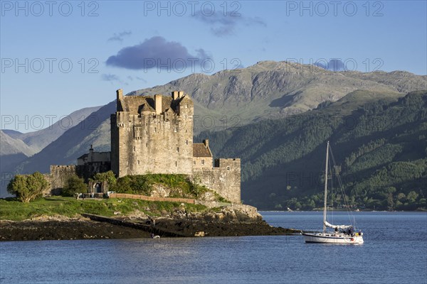 Sailing boat in front of Eilean Donan Castle in Loch Duich