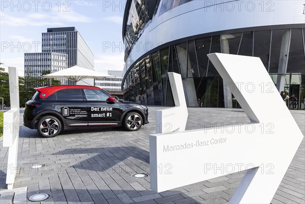 A new Smart brand vehicle in front of the Mercedes Museum in Stuttgart