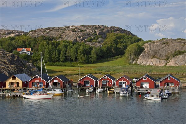 Red wooden boat huts in the harbour at Hamburgsund