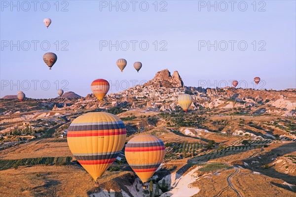 Hot air balloons flying over Cappadocia at sunrise
