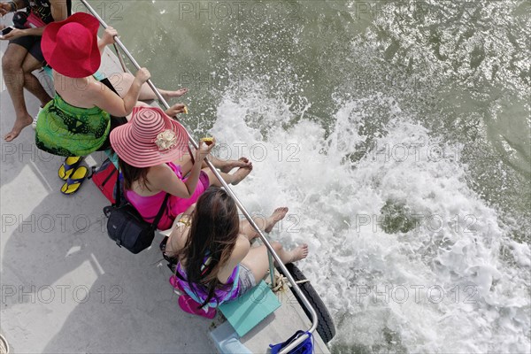 Female tourists with colourful sun hats