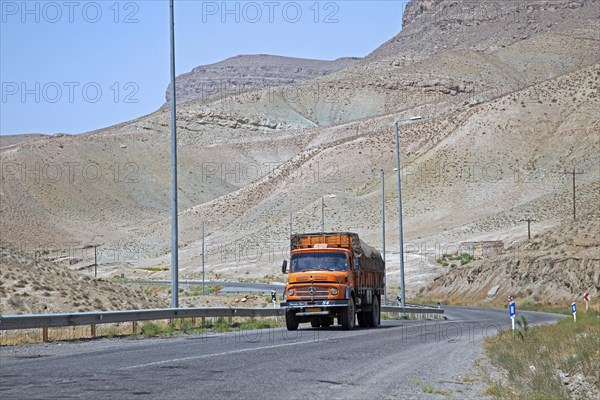 Truck on motorway from Mashhad to Turkmenistan through the Karakum Desert in Iran