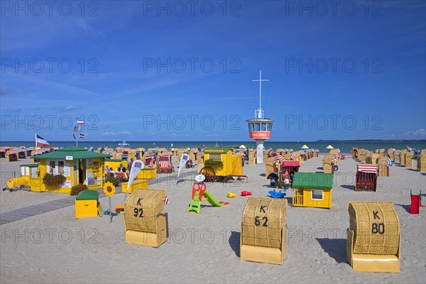 Roofed wicker beach chairs on the beach at Travemuende