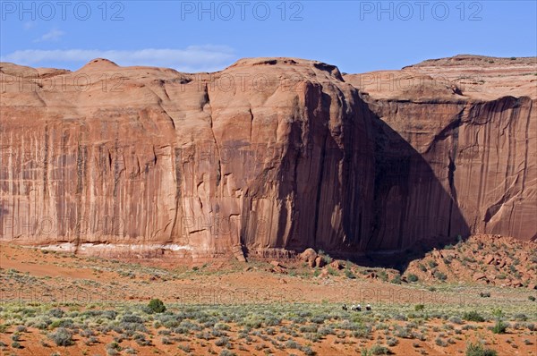 Navajo guide with tourists on horseback in front of Yei Bi Chei