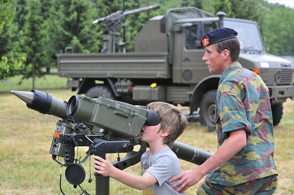 Soldier showing Mistral Air Defence Missile System to child during open day of the Belgian army at Leopoldsburg