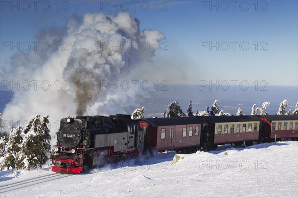 Steam train riding the Brocken Narrow Gauge railway line in the snow in winter at the Harz National park