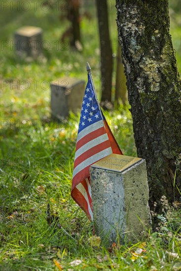 American flag at commemoration stone for fallen soldier at Bois de la Paix