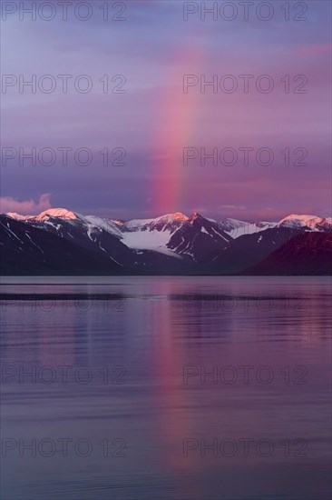 Rainbow over Liefdefjorden at sunset in summer