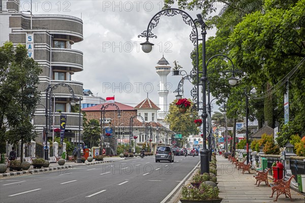 Minaret of the Grand Mosque of Bandung and Savoy Homann Bidakara Hotel in the Jalan Asia-Afrika street in the city Bandung