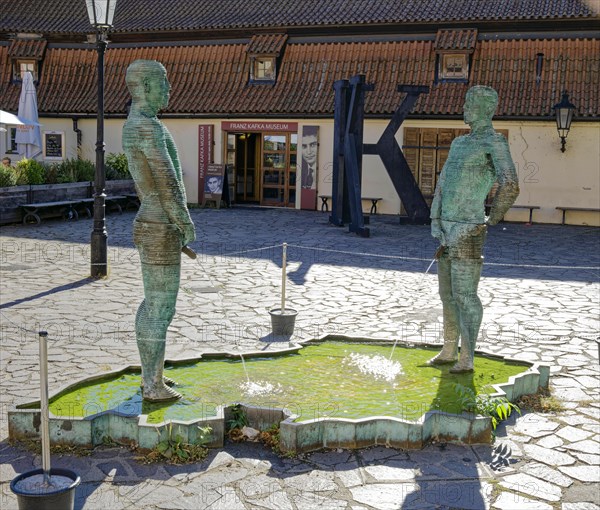 Two male figures peeing